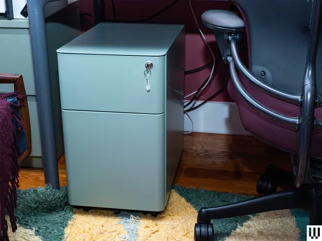 Image may contain: Furniture, Chair, Appliance, Device, Electrical Device, Refrigerator, Home Decor, Rug, and Filing Cabinet