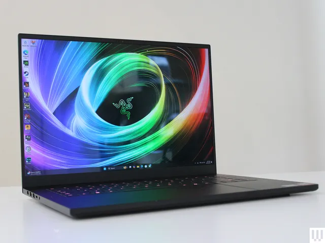 Front view of Razer Blade 16 2025 edition, a slim black laptop, with abstract art on the screen