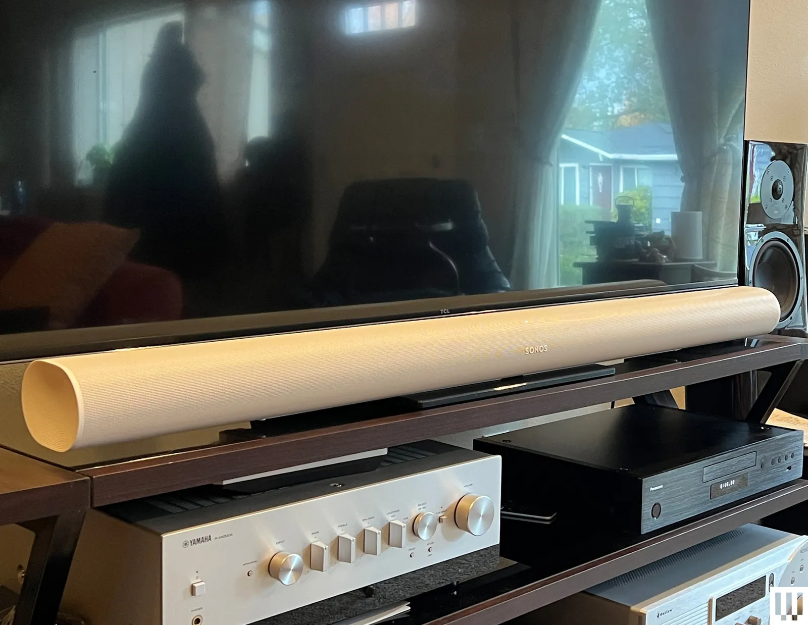 Sonos Arc Ultra Soundbar a long white speaker below a flat screen tv