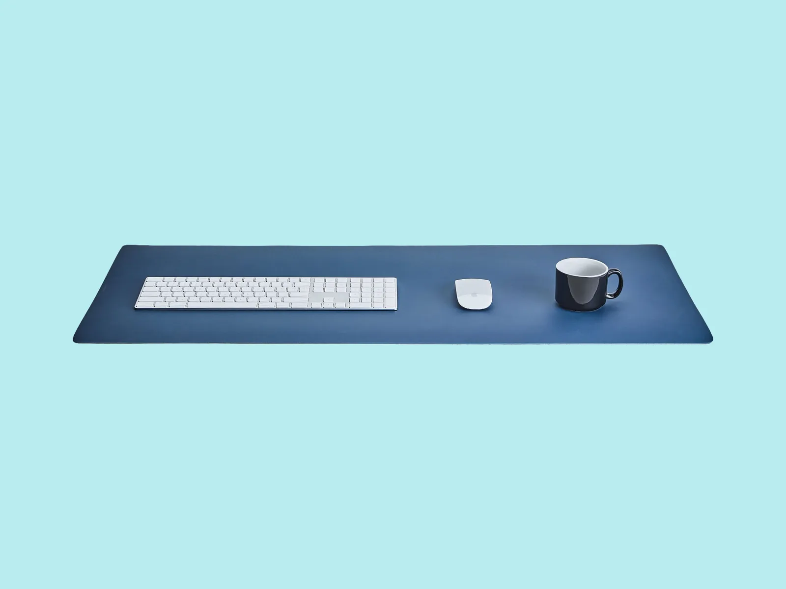 Grovemade desk pad with keyboard mouse and coffee mug on top